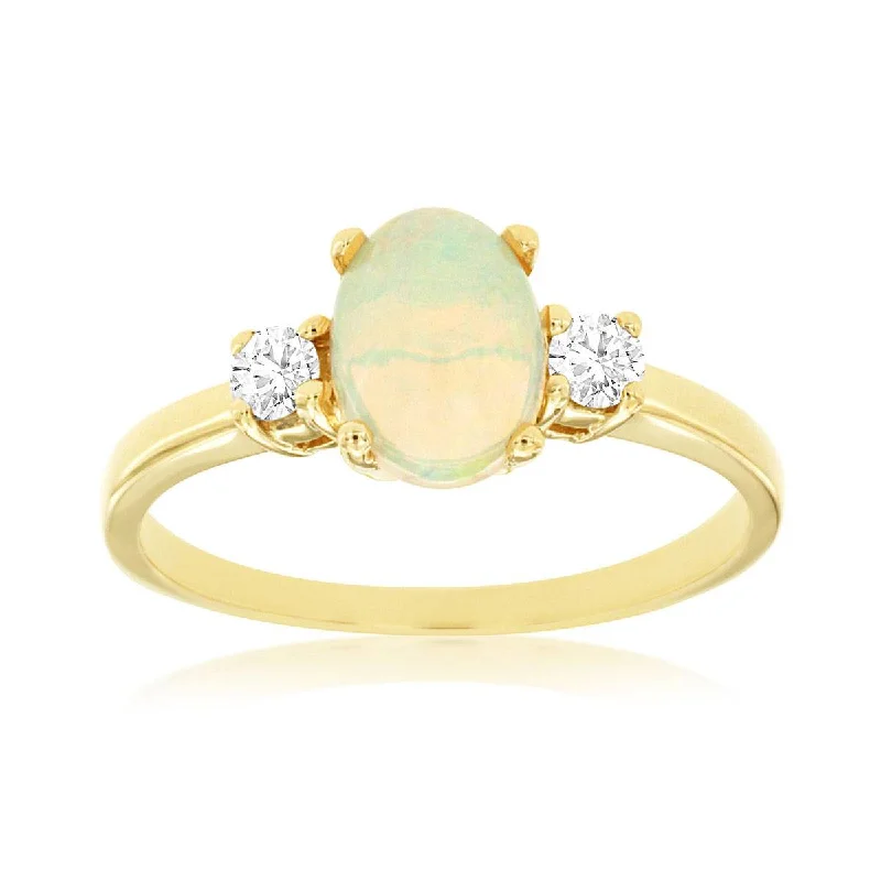 Opal and diamond engagement ring in a contemporary silver band with black - rhodium accentsThree Stone Oval Ethiopian Opal and Round Diamond Ring in Yellow Gold