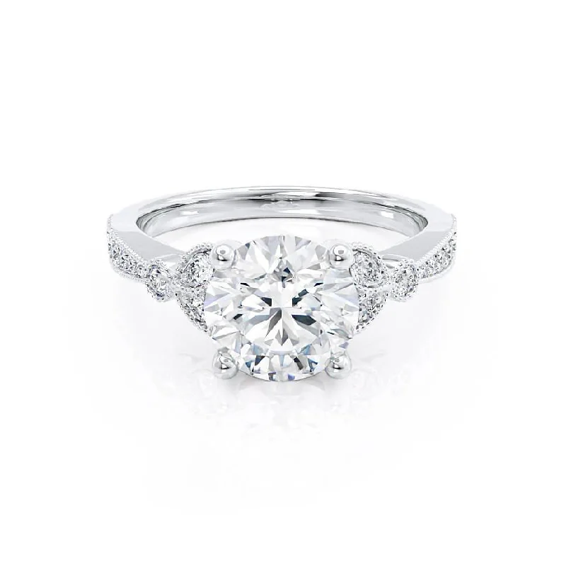 Solitaire diamond engagement ring with a platinum setting for a classic and elegant lookLILIANA - Round Moissanite & Diamond 950 Platinum Shoulder Set Ring