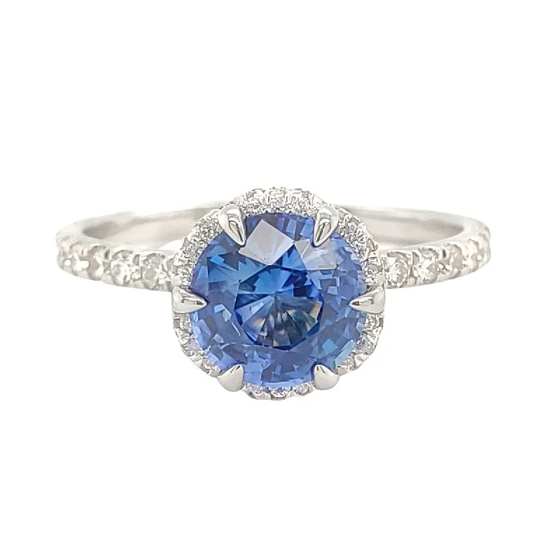 Halo diamond engagement ring in 18K white gold with a center oval - cut stoneLuminous Blue Round Sapphire Diamond Halo Pave Ring in White Gold